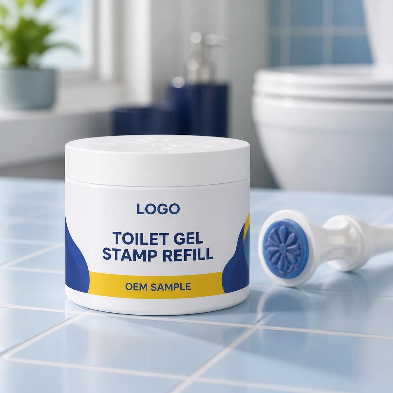 Existing white 180 g wide-mouth pot with integrated LOGO, TOILET GEL STAMP REFILL and OEM SAMPLE wrap label beside a reusable gel-stamp applicator on pale-blue tile